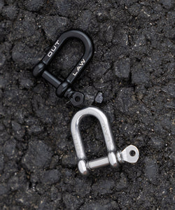 Outlaw Gear Steel D Shackles In Black and Silver On Tarmac